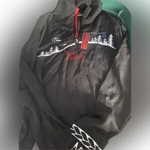 Cozy Black Turtleneck Sweater with Red Skiing Design